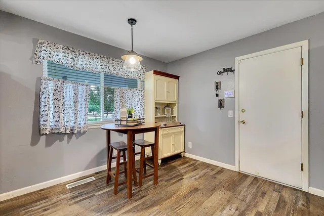 a view of a dining room with furniture window and wooden floor