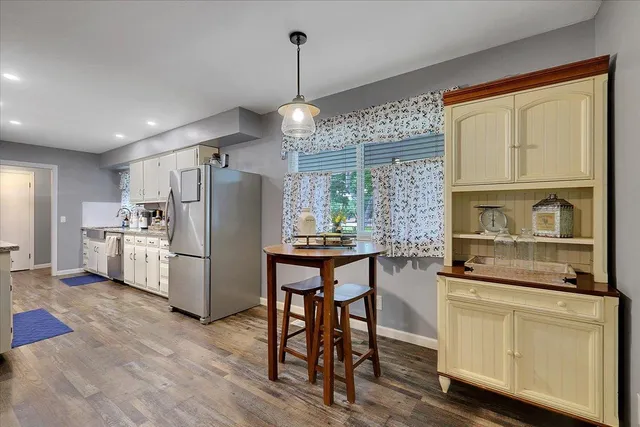 a view of a dining room with furniture and wooden floor