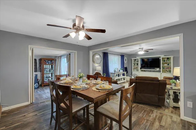 a dining room with furniture a rug and wooden floor