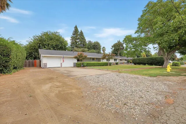 a view of a house with a yard and sitting area