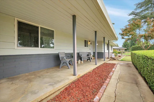 a view of a patio with dining table and chairs with wooden fence