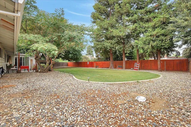 a view of a house with a backyard