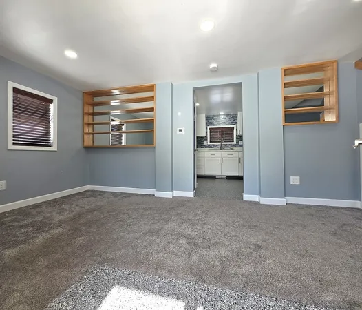 a kitchen with stainless steel appliances granite countertop a stove sink and cabinets