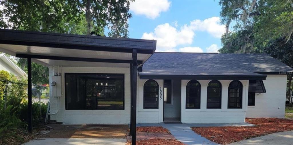 1395 Neptune Road, Unit A Kissimmee, FL 34744 - Photo 1 of 1 a front view of a house with glass windows and yard