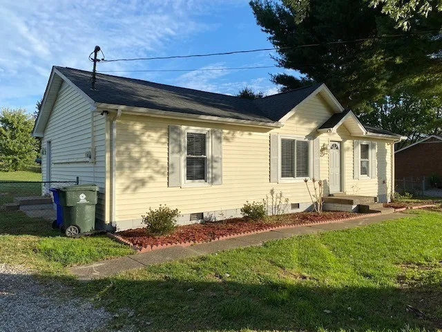 a front view of a house with a yard