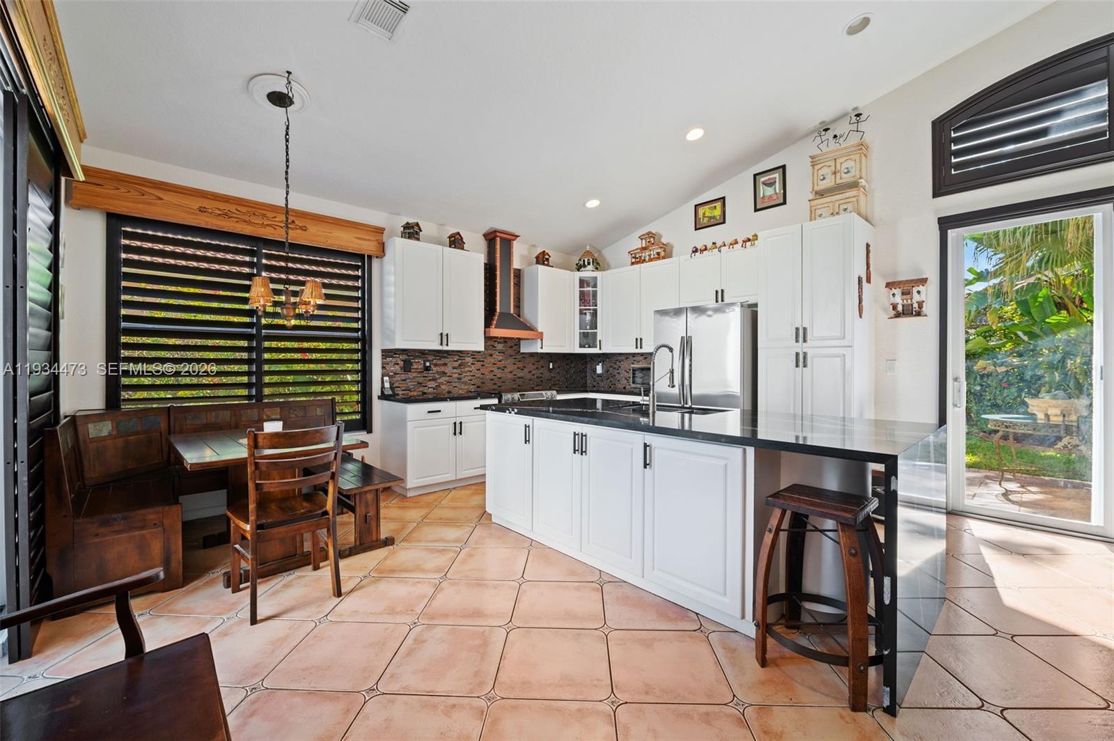 18900 Southwest 29th Street Miramar, FL 33029 - Photo 11 of 40 a kitchen with stainless steel appliances kitchen island granite countertop a stove a sink and a refrigerator