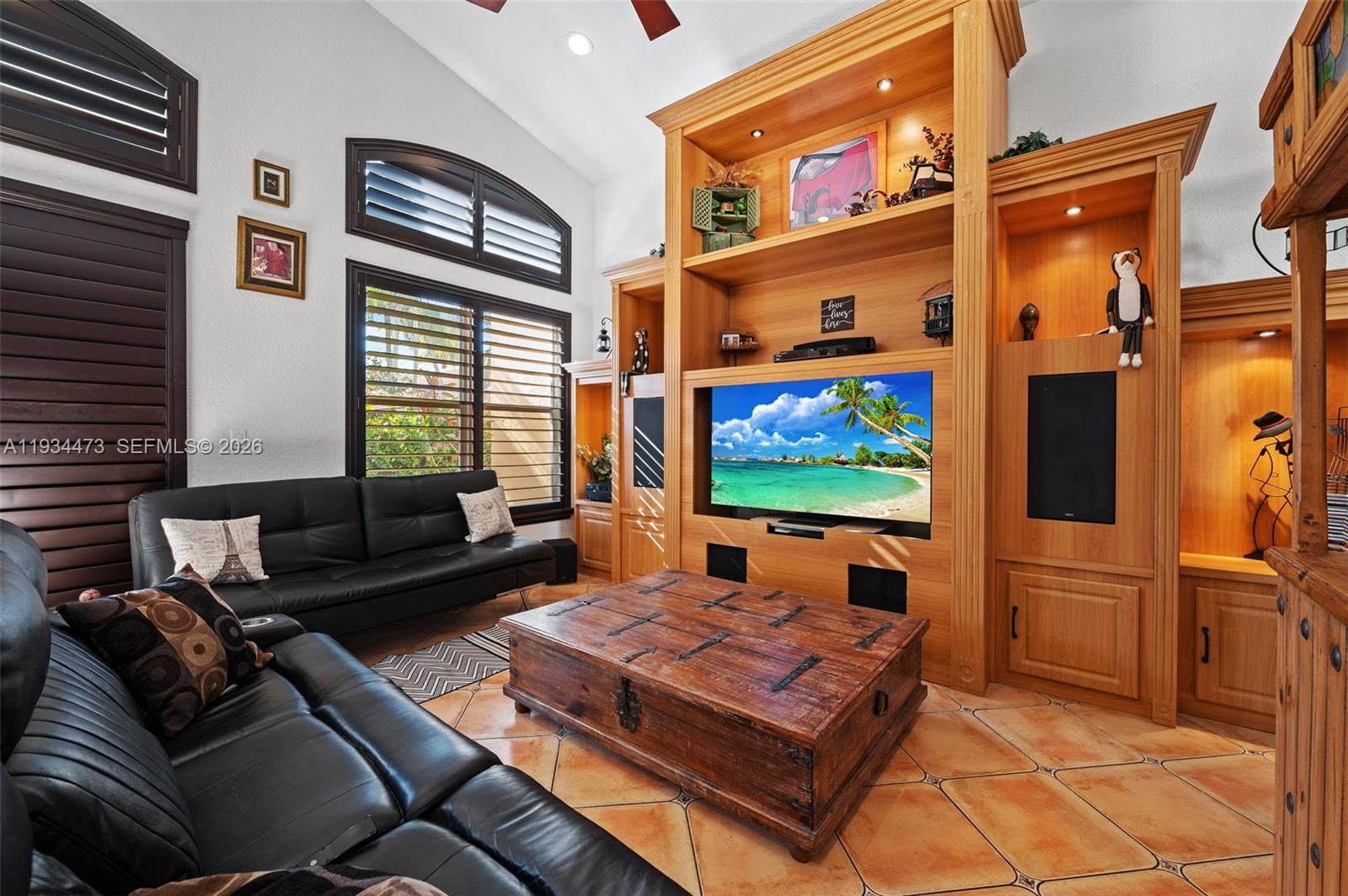 18900 Southwest 29th Street Miramar, FL 33029 - Photo 14 of 40 a living room with furniture a flat screen tv and a fireplace