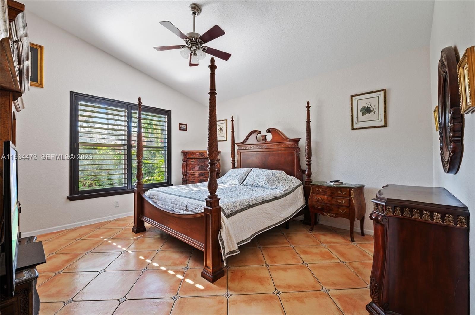 18900 Southwest 29th Street Miramar, FL 33029 - Photo 15 of 40 a bedroom with a bed and a chandelier