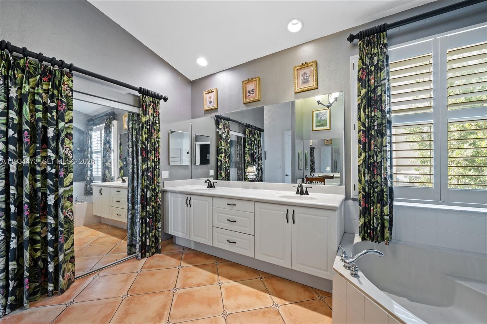 18900 Southwest 29th Street Miramar, FL 33029 - Photo 18 of 40 a spacious bathroom with a tub sink and mirror