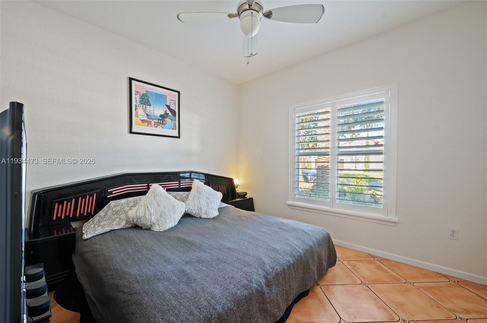 18900 Southwest 29th Street Miramar, FL 33029 - Photo 19 of 40 a bedroom with a bed and a window