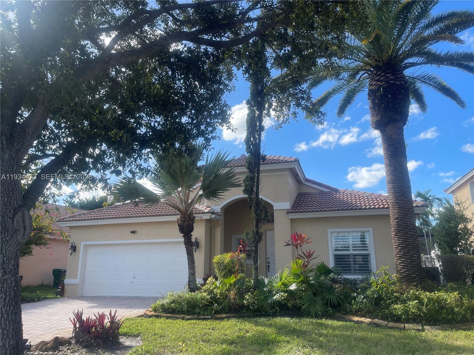 18900 Southwest 29th Street Miramar, FL 33029 - Photo 2 of 40 a front view of a house with a garden