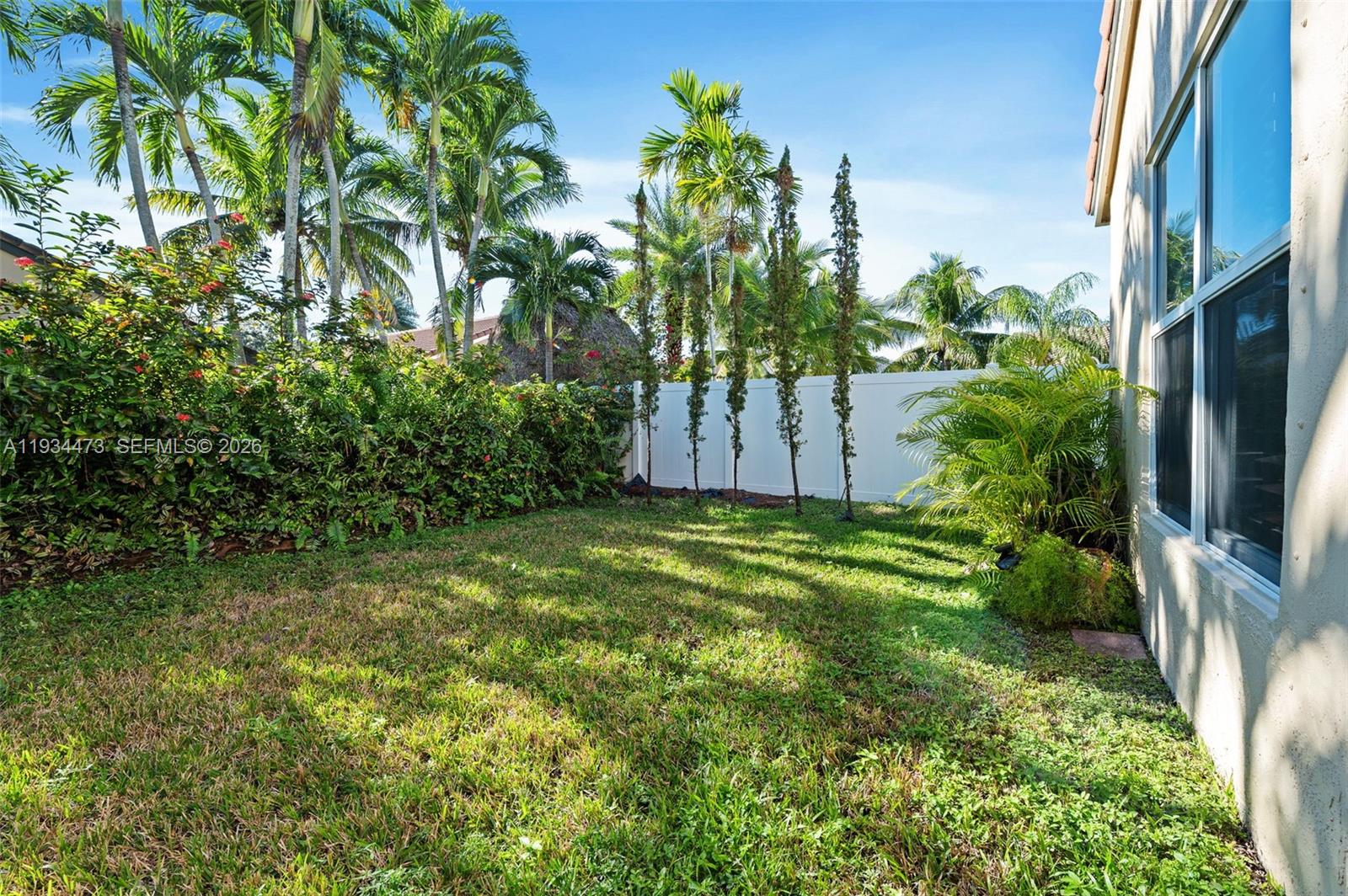 18900 Southwest 29th Street Miramar, FL 33029 - Photo 26 of 40 a view of a yard with table and potted plants