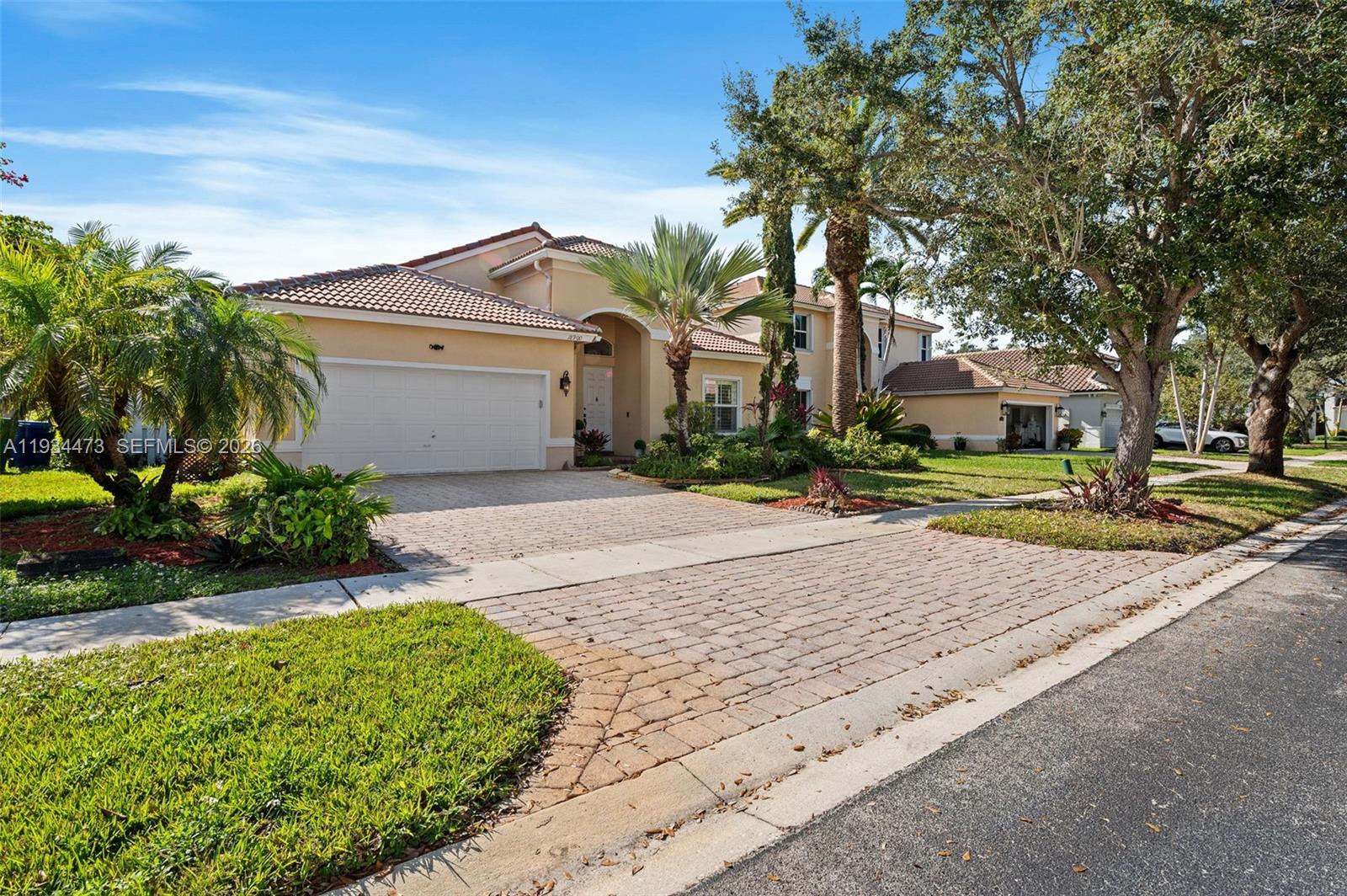 18900 Southwest 29th Street Miramar, FL 33029 - Photo 4 of 40 a front view of a house with a yard and a garage