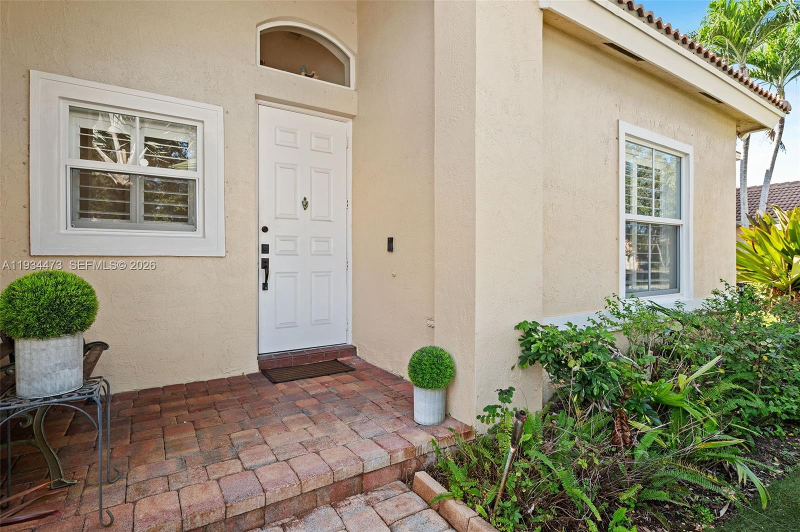 18900 Southwest 29th Street Miramar, FL 33029 - Photo 5 of 40 a view of a backyard with a chair and potted plants