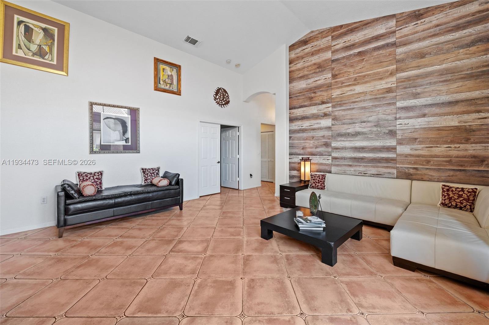 18900 Southwest 29th Street Miramar, FL 33029 - Photo 7 of 40 a living room with furniture and a mirror