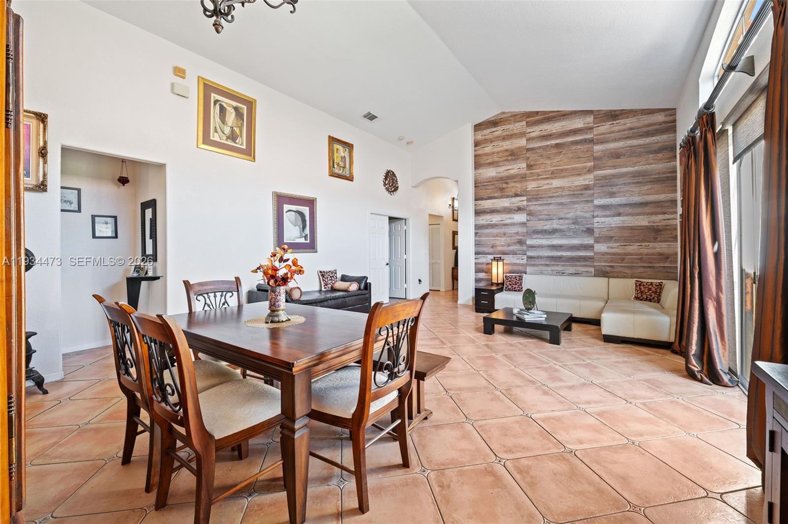 18900 Southwest 29th Street Miramar, FL 33029 - Photo 9 of 40 a view of a dining room with furniture and a chandelier