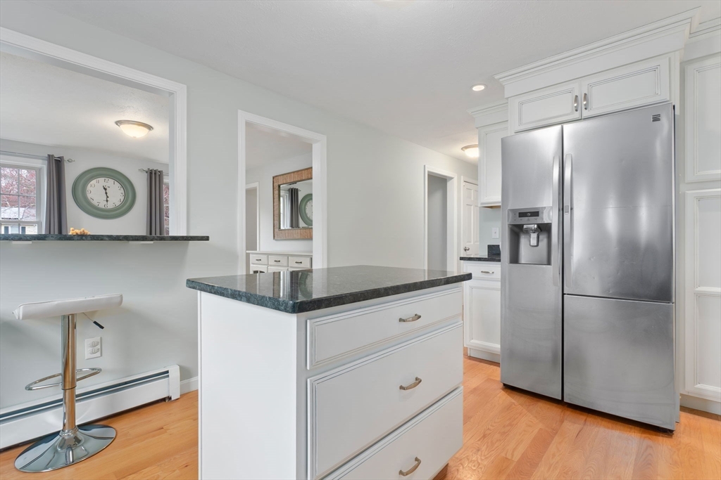 4 Brookside Court Methuen, MA 01844 - Photo 12 of 39 a kitchen with granite countertop a refrigerator and a cabinets