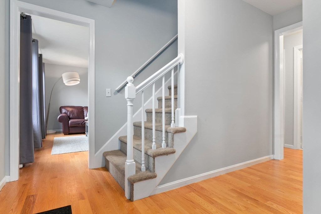4 Brookside Court Methuen, MA 01844 - Photo 19 of 39 a view of a bedroom with wooden floor and stairs
