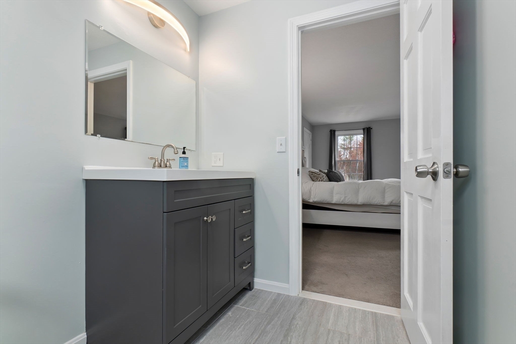 4 Brookside Court Methuen, MA 01844 - Photo 27 of 39 a en suite bathroom with a sink a mirror and a vanity