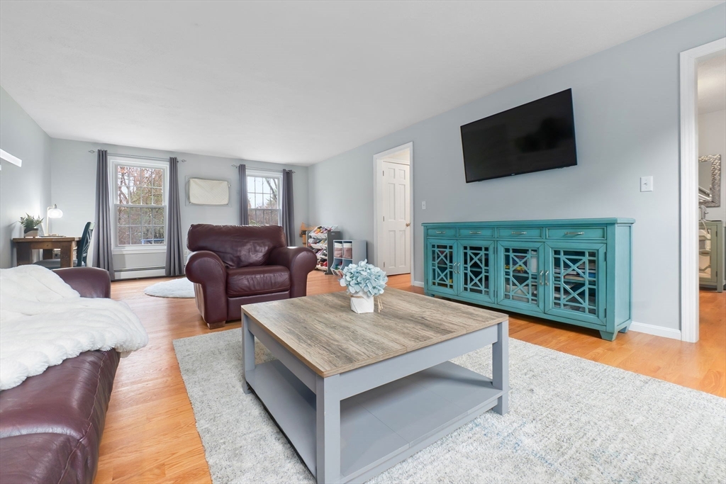 4 Brookside Court Methuen, MA 01844 - Photo 5 of 39 a living room with furniture a flat screen tv and a fireplace