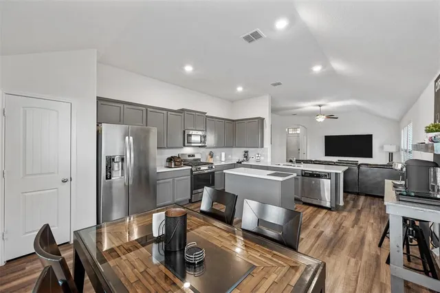 a view of a dining room with furniture and wooden floor