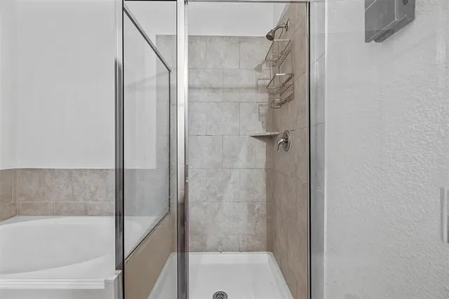 a bathroom with a tub and shower