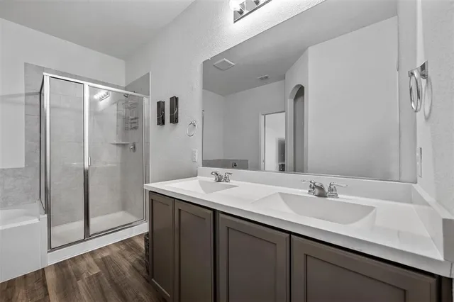 a white bath tub sitting next to a shower