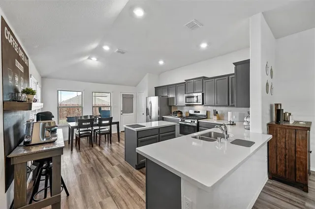 a kitchen with lots of counter top space and stainless steel appliances