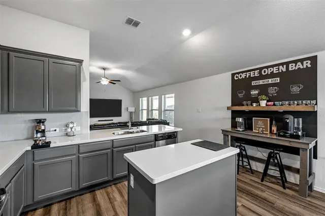a kitchen with a sink stove and microwave