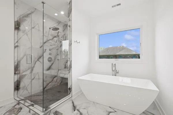 a bathroom with a bathtub and shower