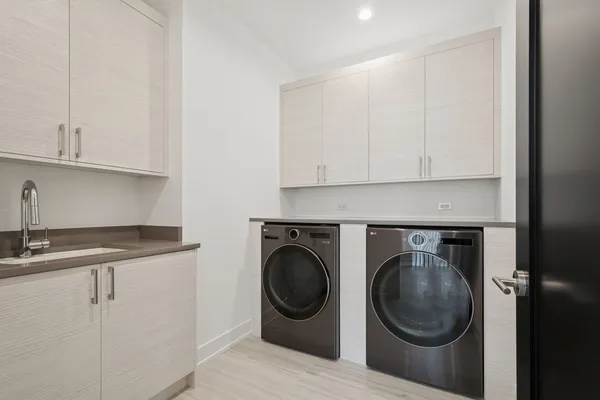a utility room with sink dryer and washer