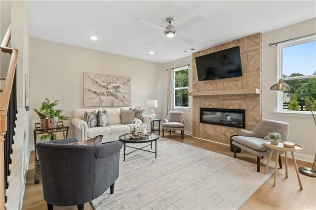 a living room with furniture and a wooden floor