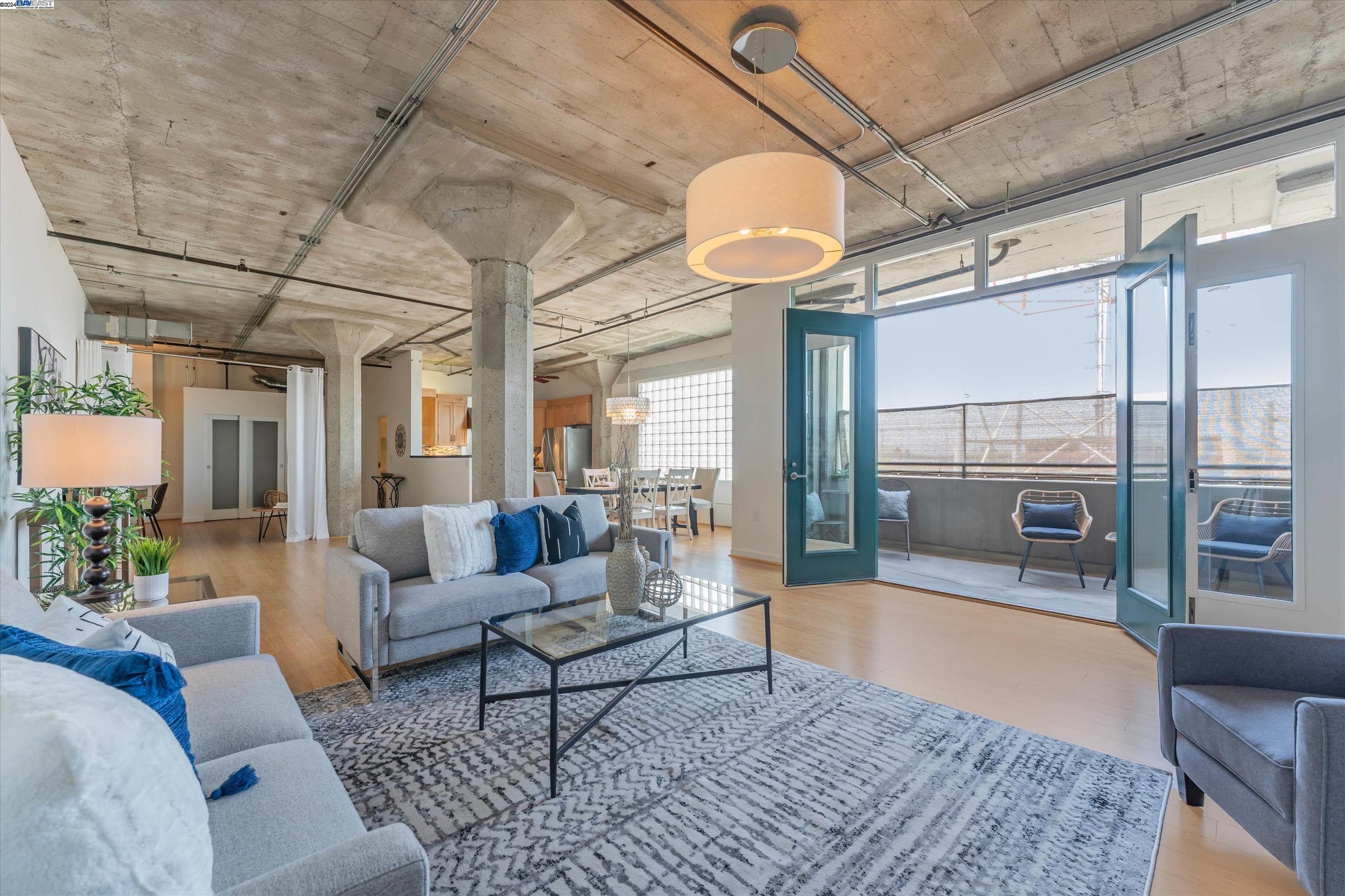 737 2nd Street, Unit 310 Oakland, CA 94607 - Photo 1 of 1 a living room with furniture and a large window