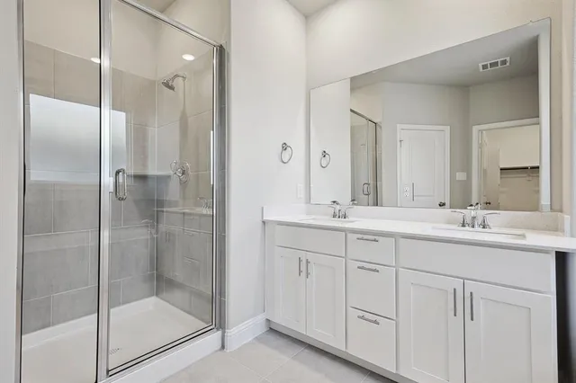 a bathroom with a shower sink and mirror
