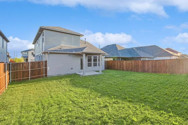 a view of a house with a backyard