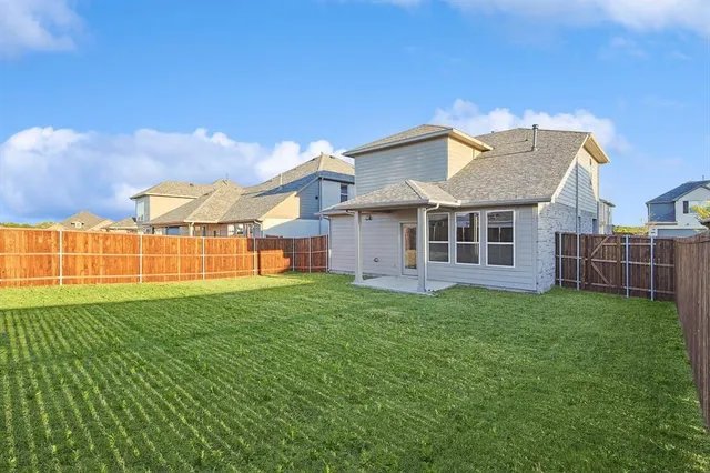 a view of a backyard with a garden and deck
