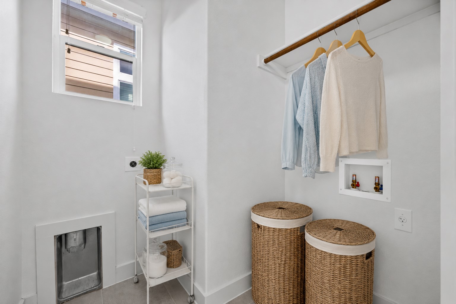 2303 Capulet Street Austin, TX 78741 - Photo 10 of 24 This bright laundry room features washer and dryer hookups, along with a convenient hanging bar for added functionality. A window with blinds brings in natural light while maintaining privacy. This picture is virtually staged.