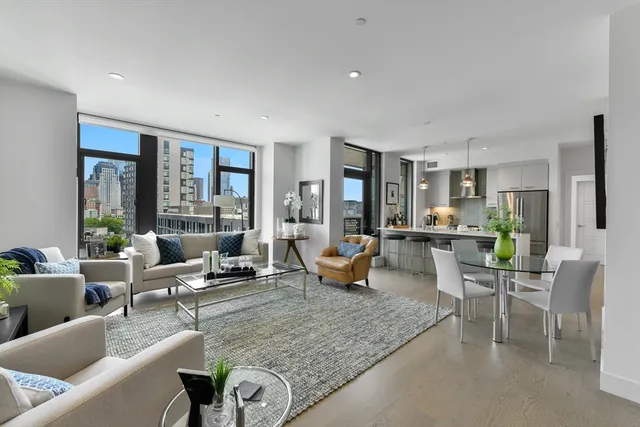 a living room with furniture and large windows