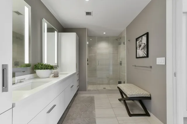 a bathroom with a tub sink and mirror