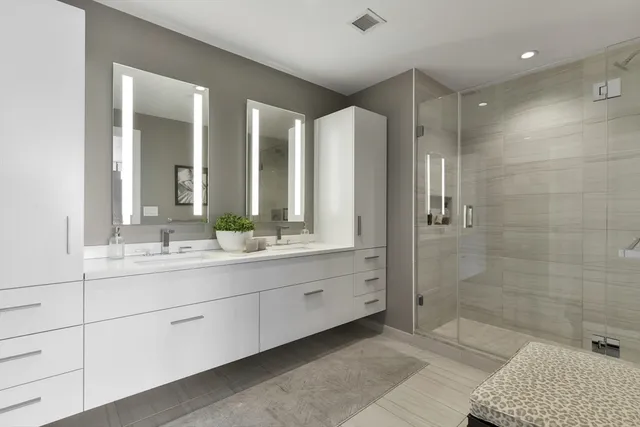 a bathroom with a double vanity sink and mirror