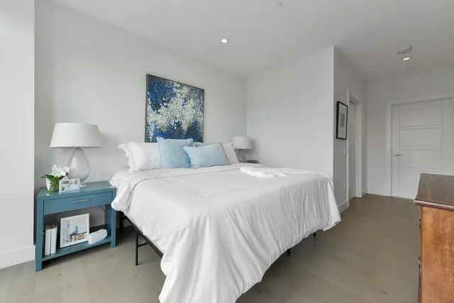 a bedroom with a bed and a lamp on table