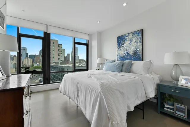 a bedroom with a large bed and a large window