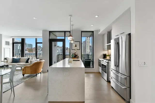 a kitchen with stainless steel appliances granite countertop a refrigerator and a stove top oven