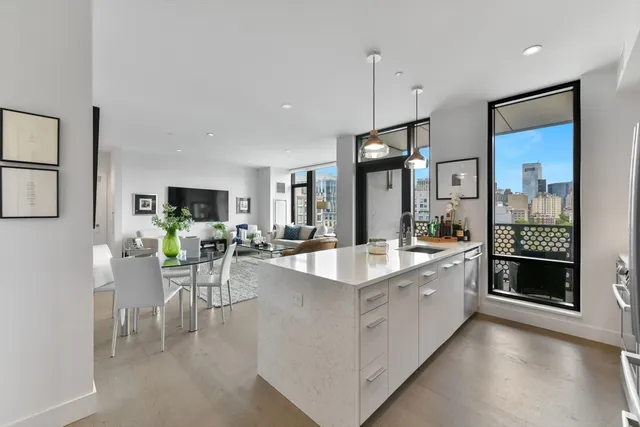 a large kitchen with a table and chairs