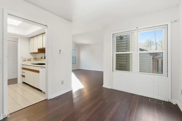 a white refrigerator freezer and a wooden floor