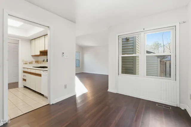a white refrigerator freezer and a wooden floor