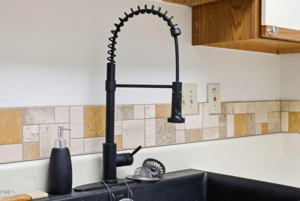 a kitchen with a sink and a refrigerator
