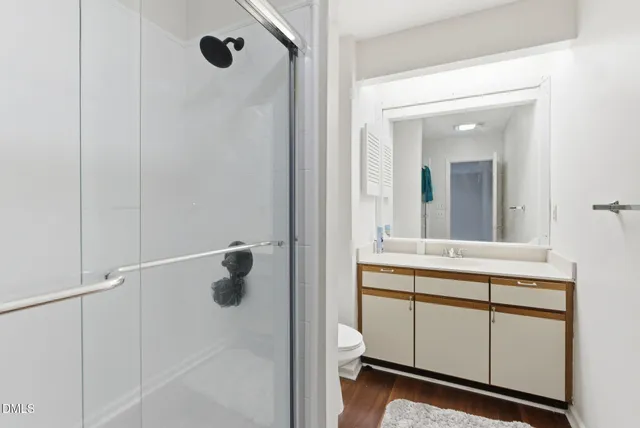 a bathroom with a sink toilet and shower