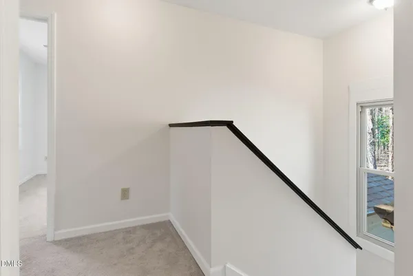 a view of an empty room with a ceiling fan