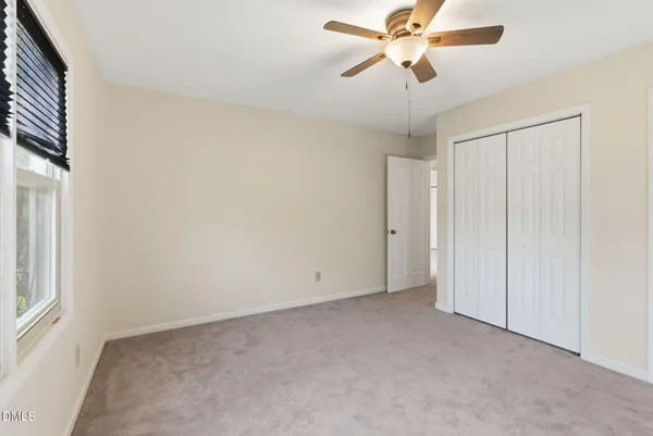 a view of a backyard with a wooden fence
